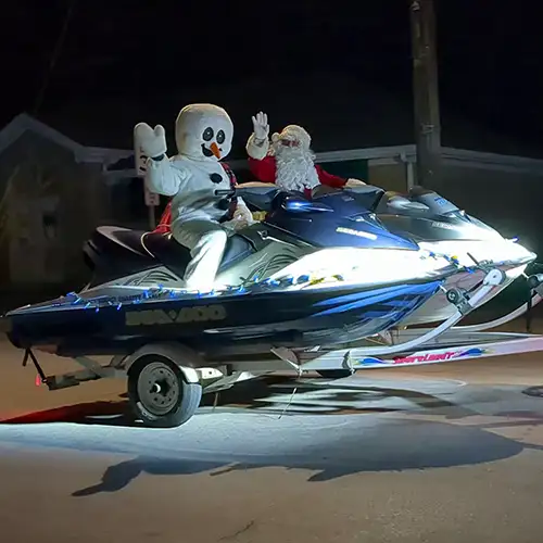 Santa and snowman riding jet skis in the 2022 parade